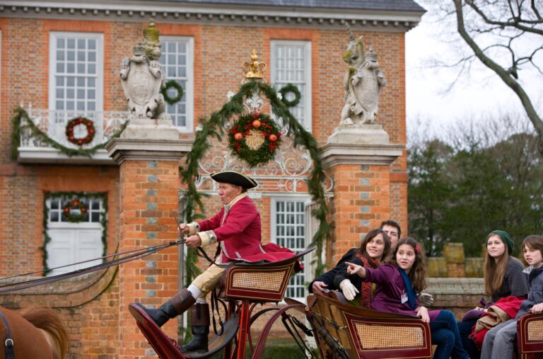 Model released visitors tour on Palace Green in an open carriage during the Christmas Season. Colonial Williamsburg's Historic Area.
